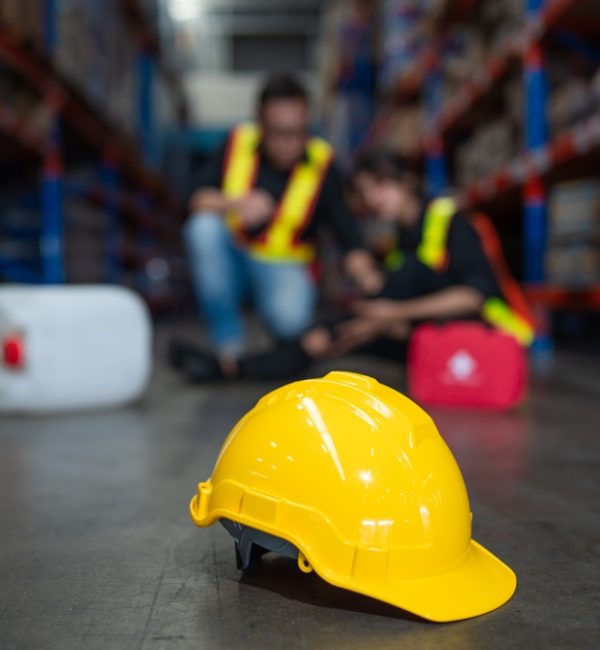 Mature,Foreman,In,Workwear,Giving,First,Aid,To,Asian,Women